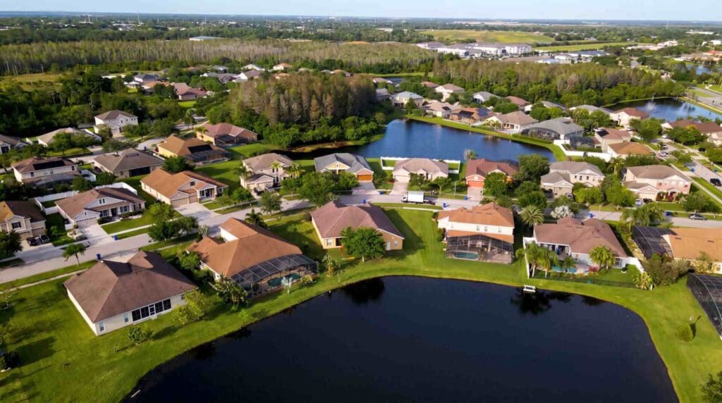 Aerial view of a suburban neighborhood in St. Cloud FL with curved streets, single‑family homes, lakes, and well‑kept lawns, reflecting the community served by local garage door repair.